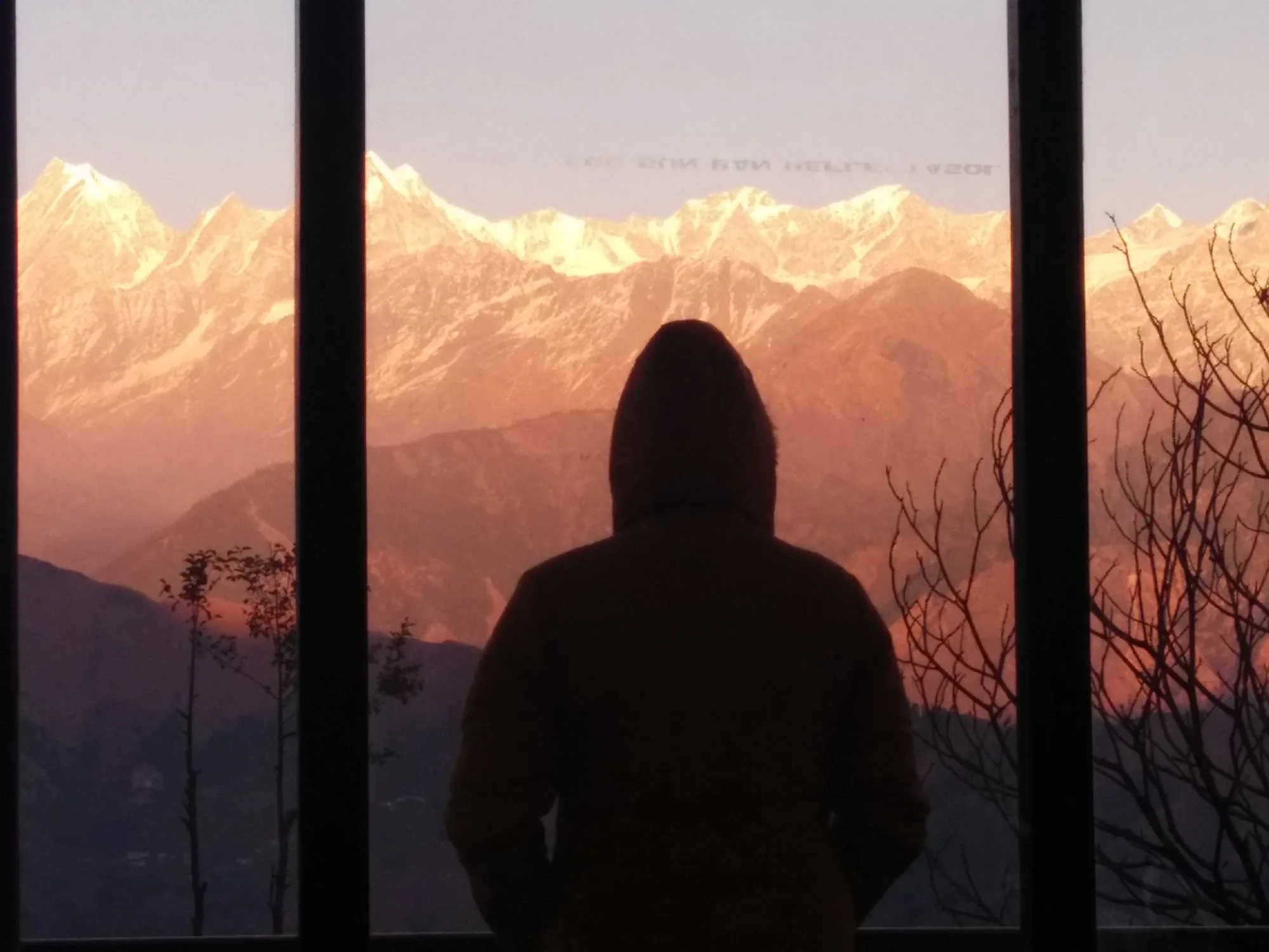 Guest silhouetted against golden Panchachuli sunrise — TripAdvisor guest photo